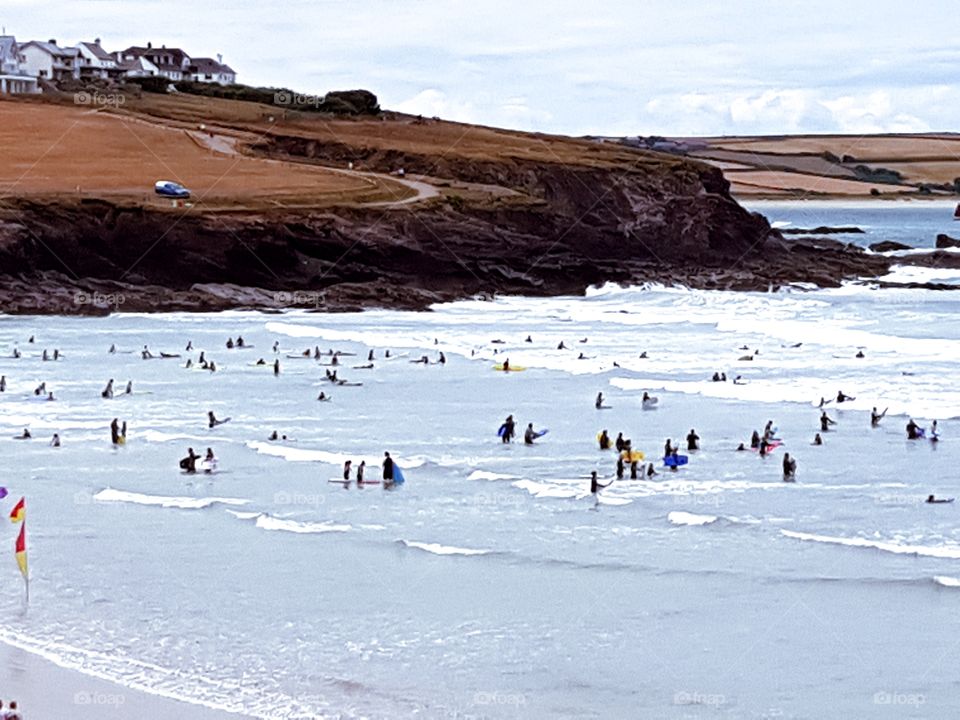 surfers and bodyboarders all enjoying a sunny afternoon at Polzeath