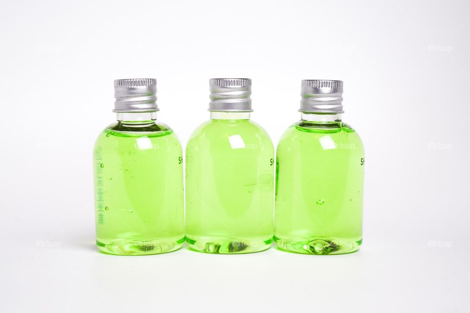 Small bottles filled with green cream.