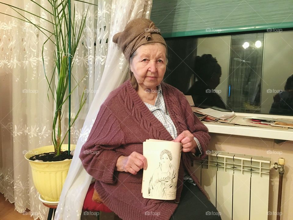 My 86 y.o. grandmother holding her art. Being born in Donbas after Second World War she had difficult and hungry childhood. But she raised me up, investing in me kindness and all the best she had found in life. Today she devotes herself to drawing.