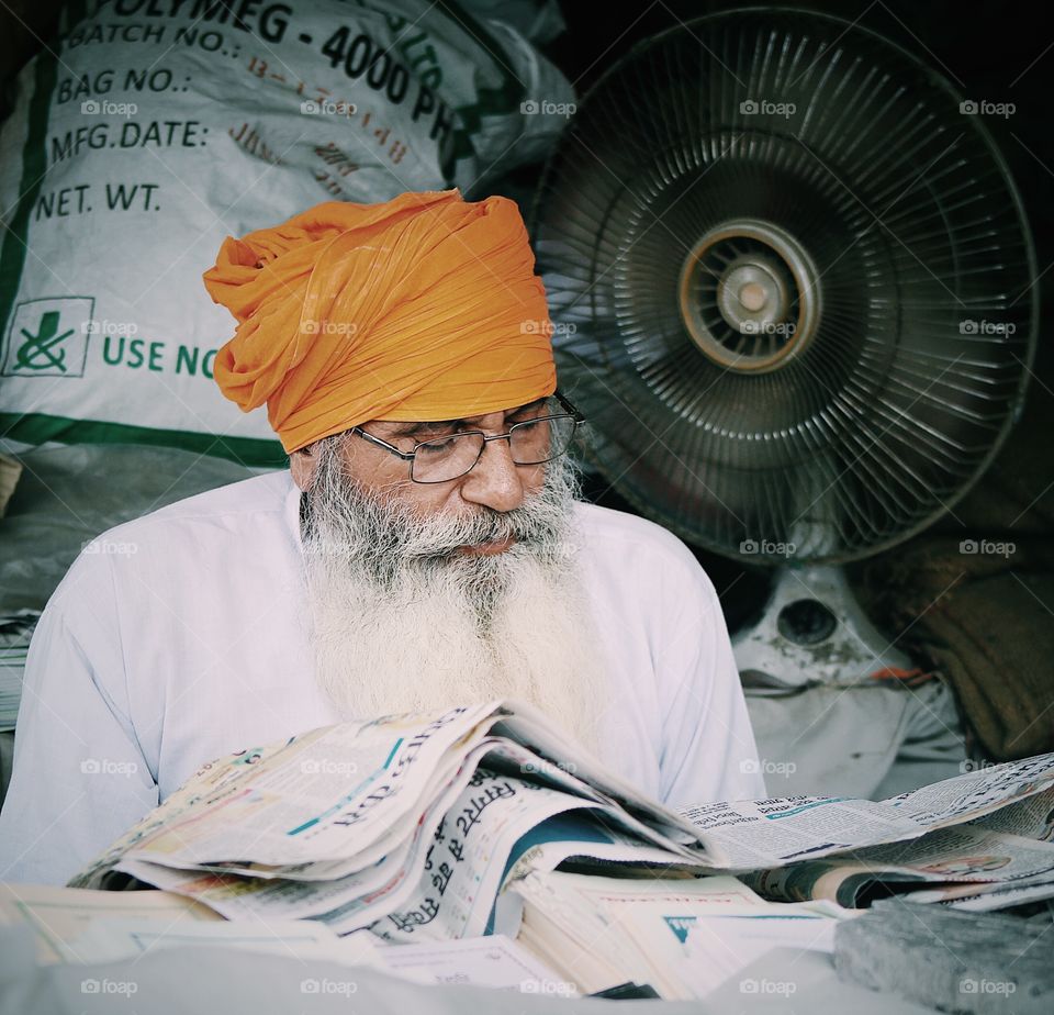 Senior man reading news paper