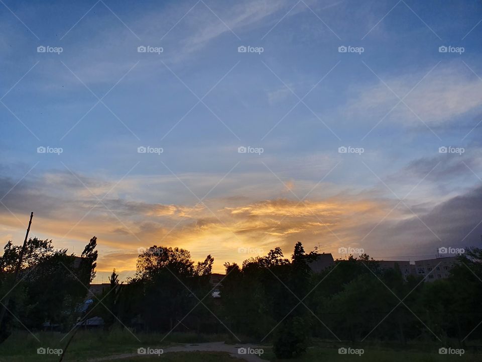urban sunset view with trees buildings snd trail