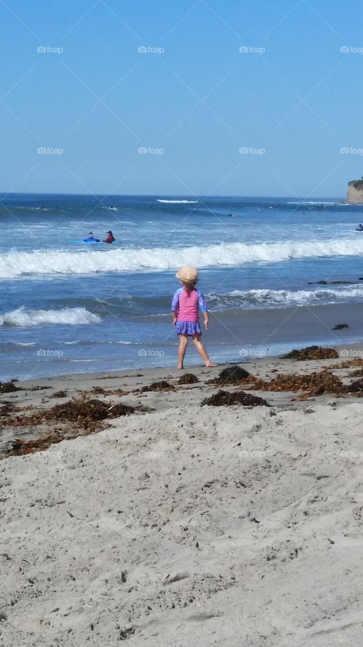 Child Walking Past Waves