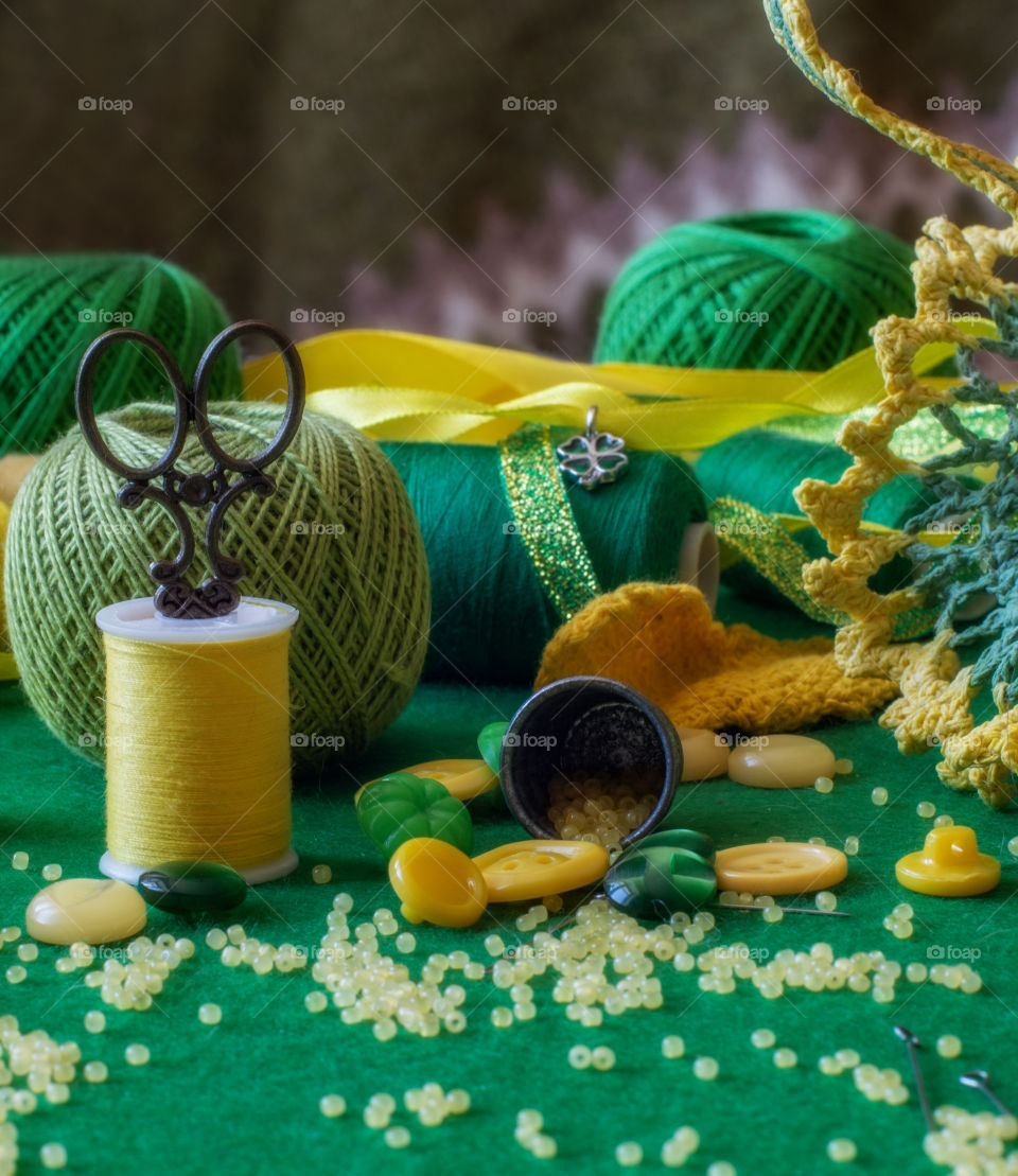 Yellow and green. Still life of sewing and knitting tools and materials.