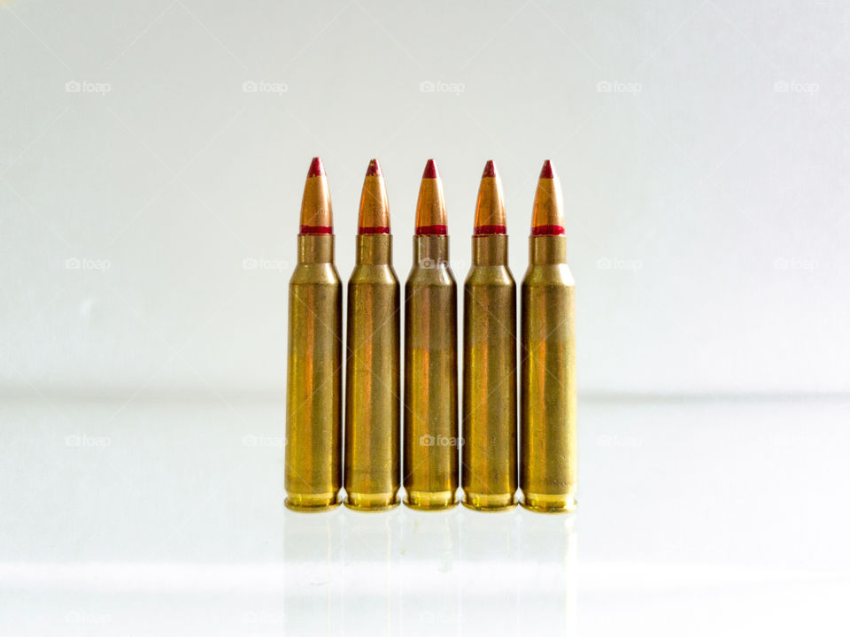 five Isolated Bullets On white Background With Reflection