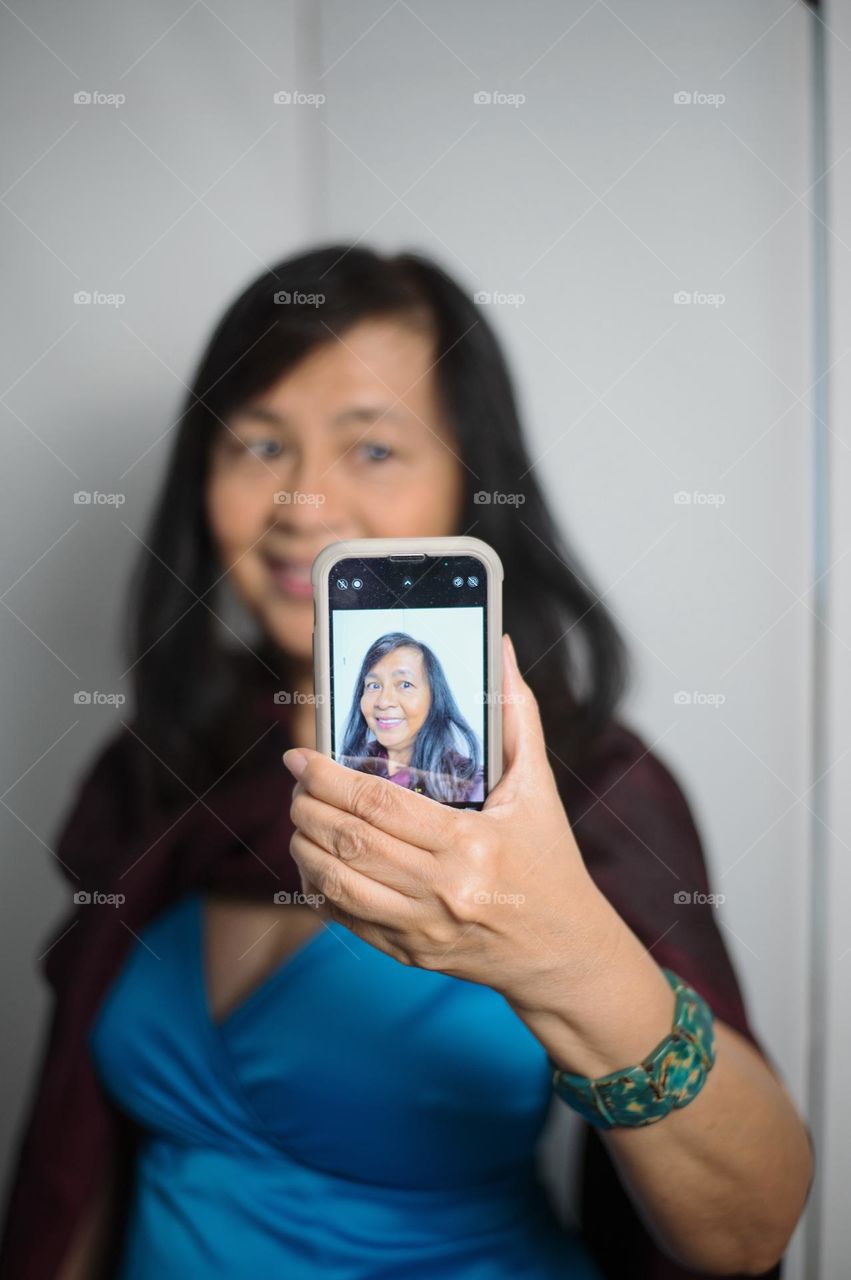 Portrait of a woman taking a selfie 