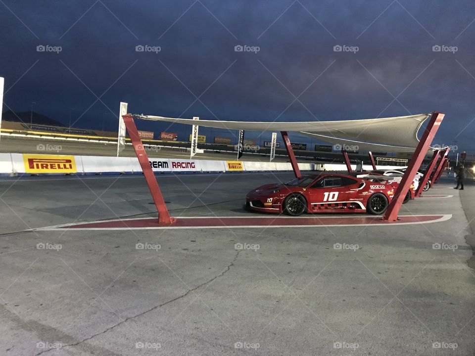 Red sports car covered at the track