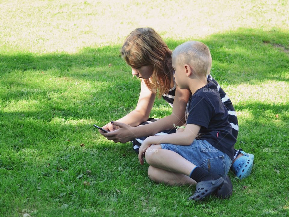 Boy and a girl looking on a phone