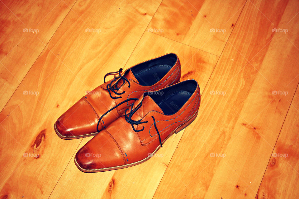 Two brown leather shoes ready to walk away.