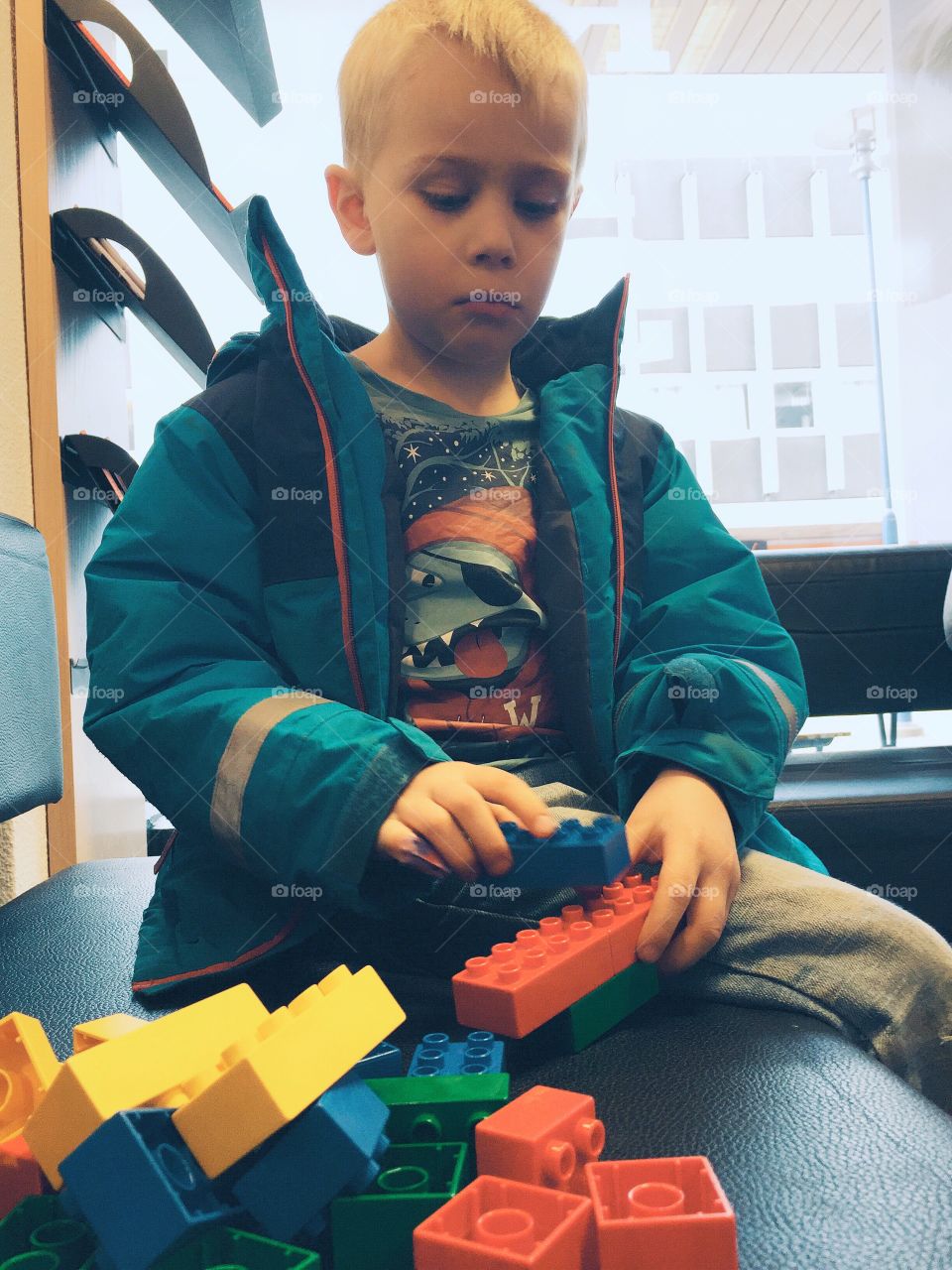 Boy playing with lego at the waiting room