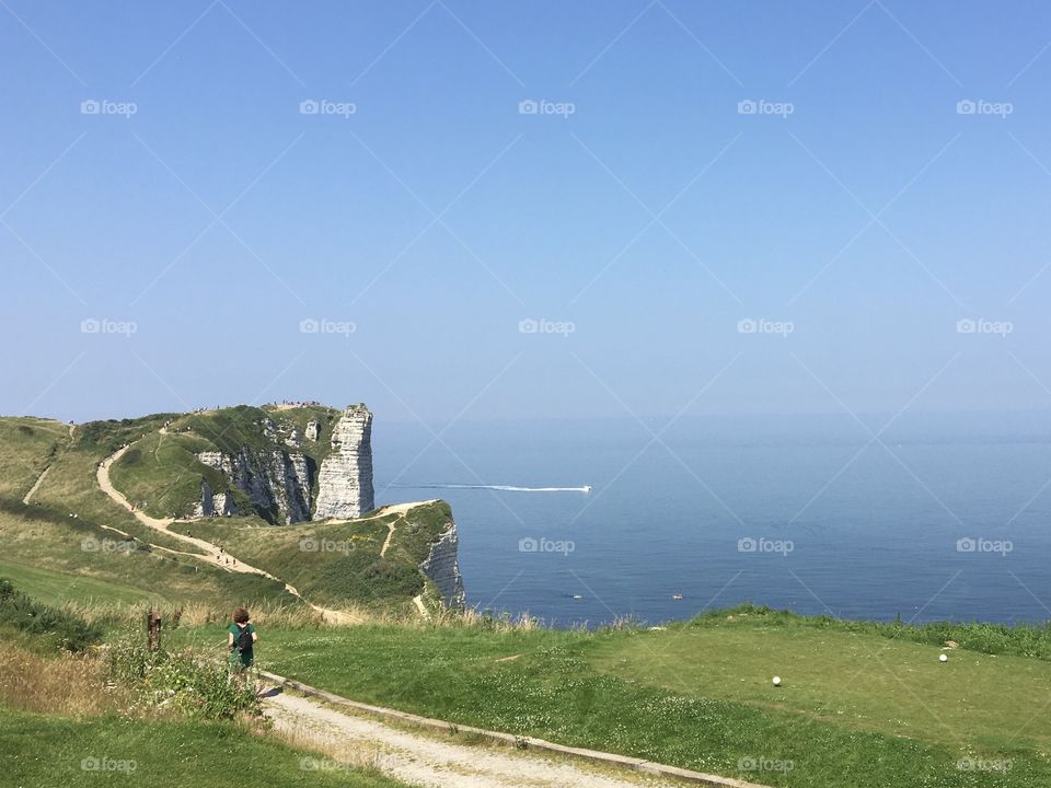 Walking along seashore with cliffs 