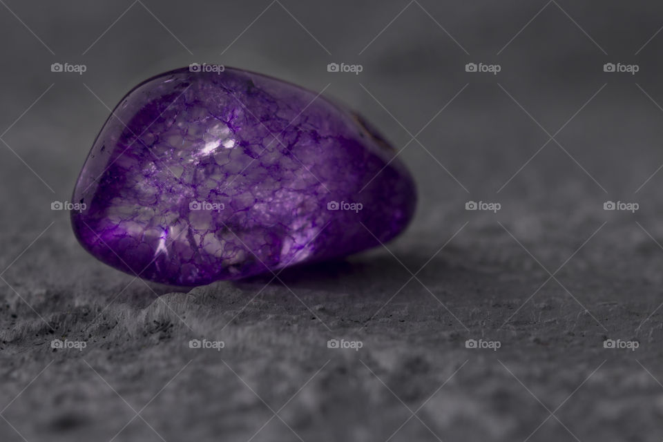 macro shot of the beautiful purple or violet stone on a concrete background.  close up view. amazing macro picture
