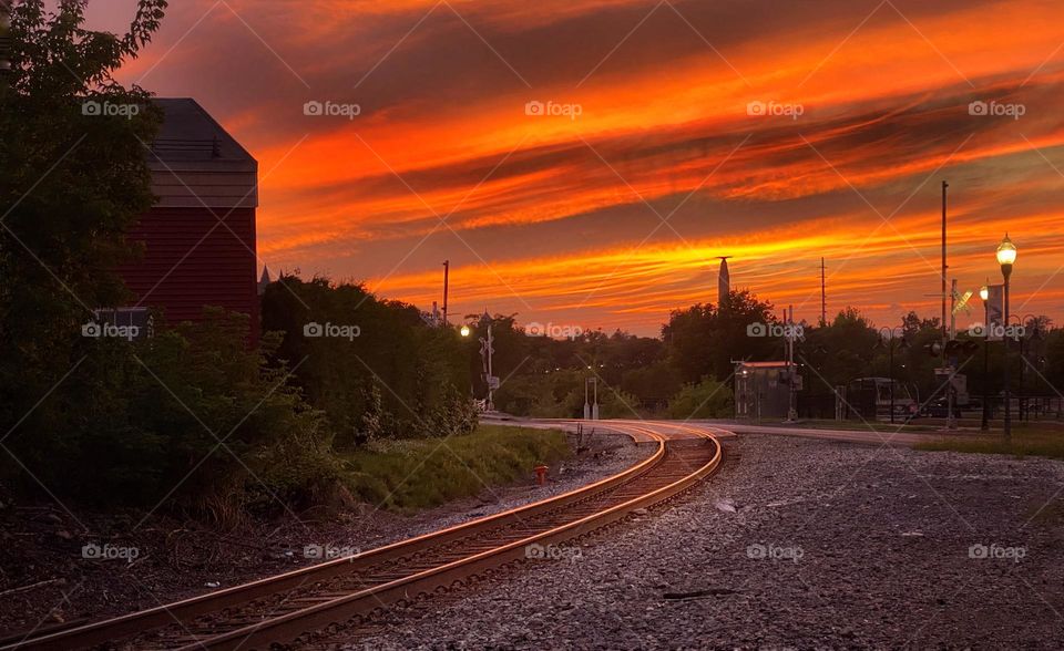 Train tracks glowing red at sunset 