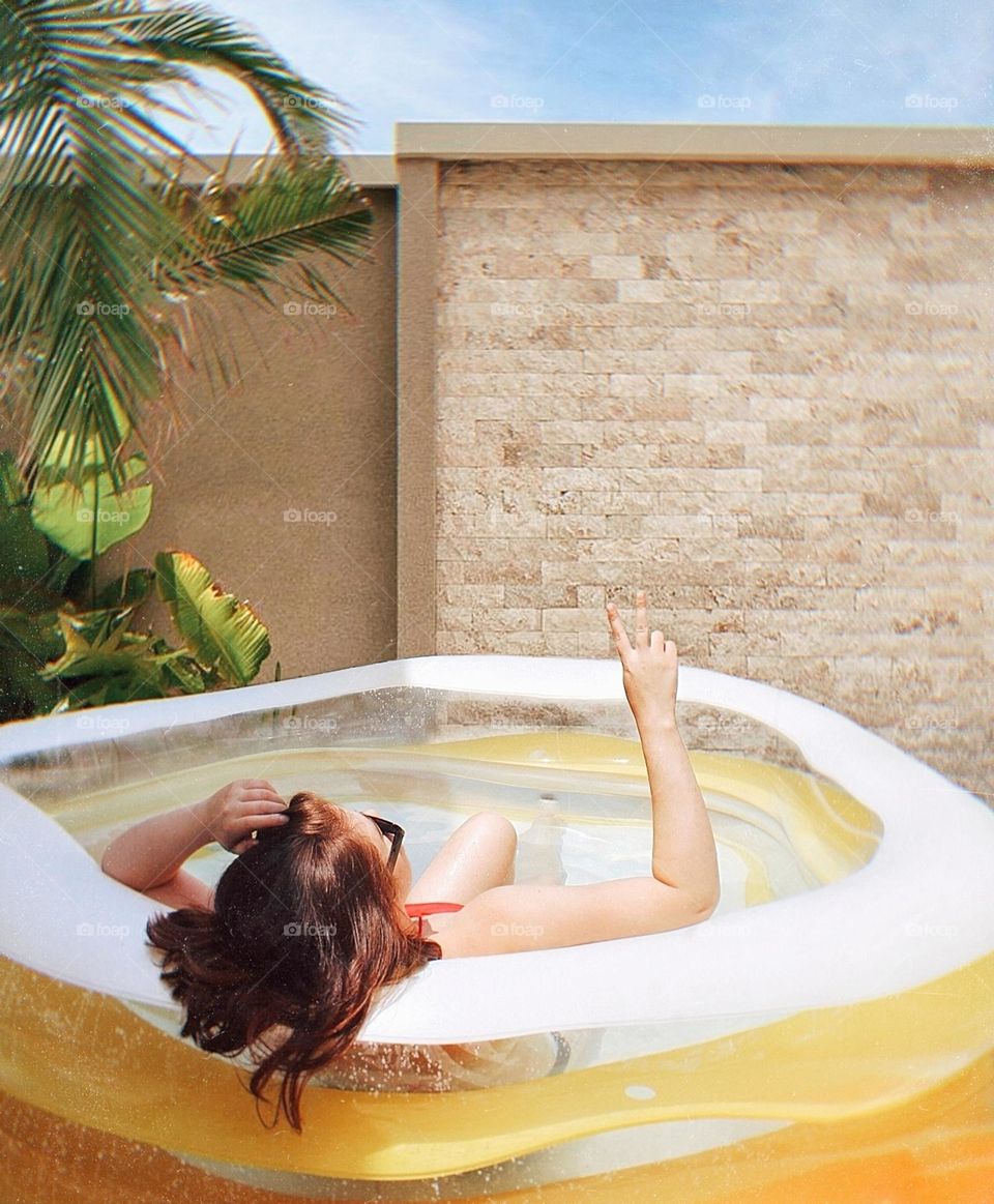 Girl relaxing in a swimming pool