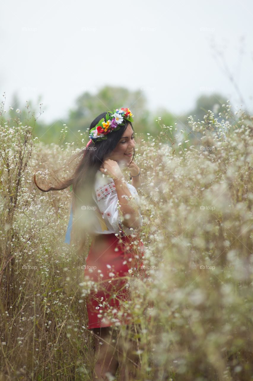 Woman wearing wreath and enjoying at field