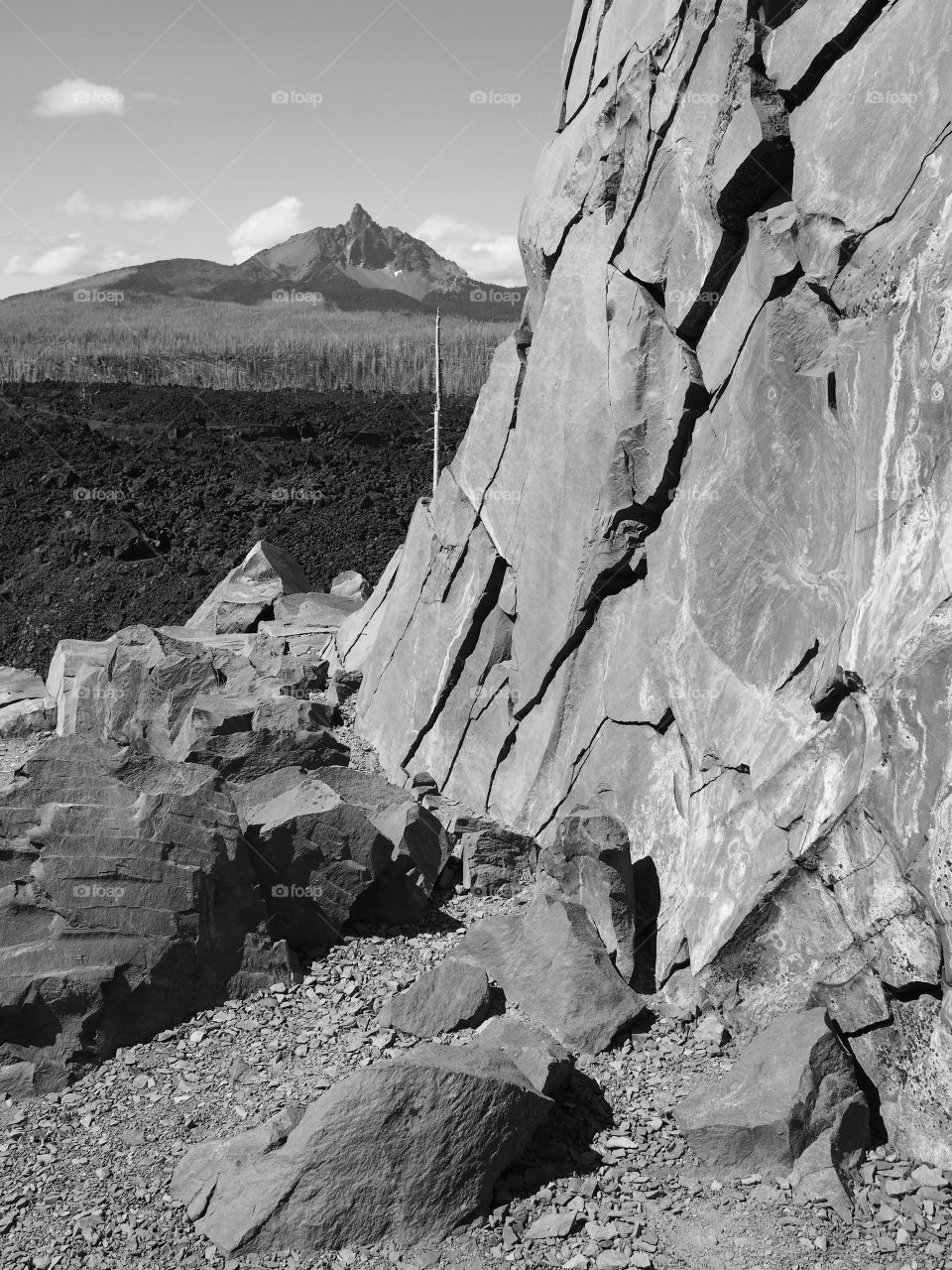 Jagged rock cliff with Mt. Washington in the background 