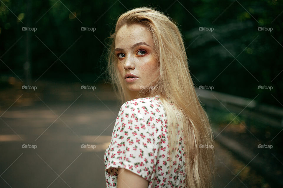 portrait photo of a young woman in nature