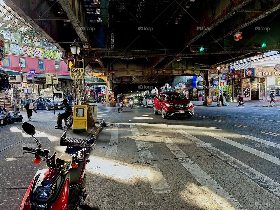 This is the sun drenched intersection and MTA “M” train overpass at “Myrtle Avenue”, “Broadway” and “Jefferson Street” in “Bushwick”, Brooklyn, also the “Myrtle Avenue” “M” train station. 2024. Hypnotic Productions