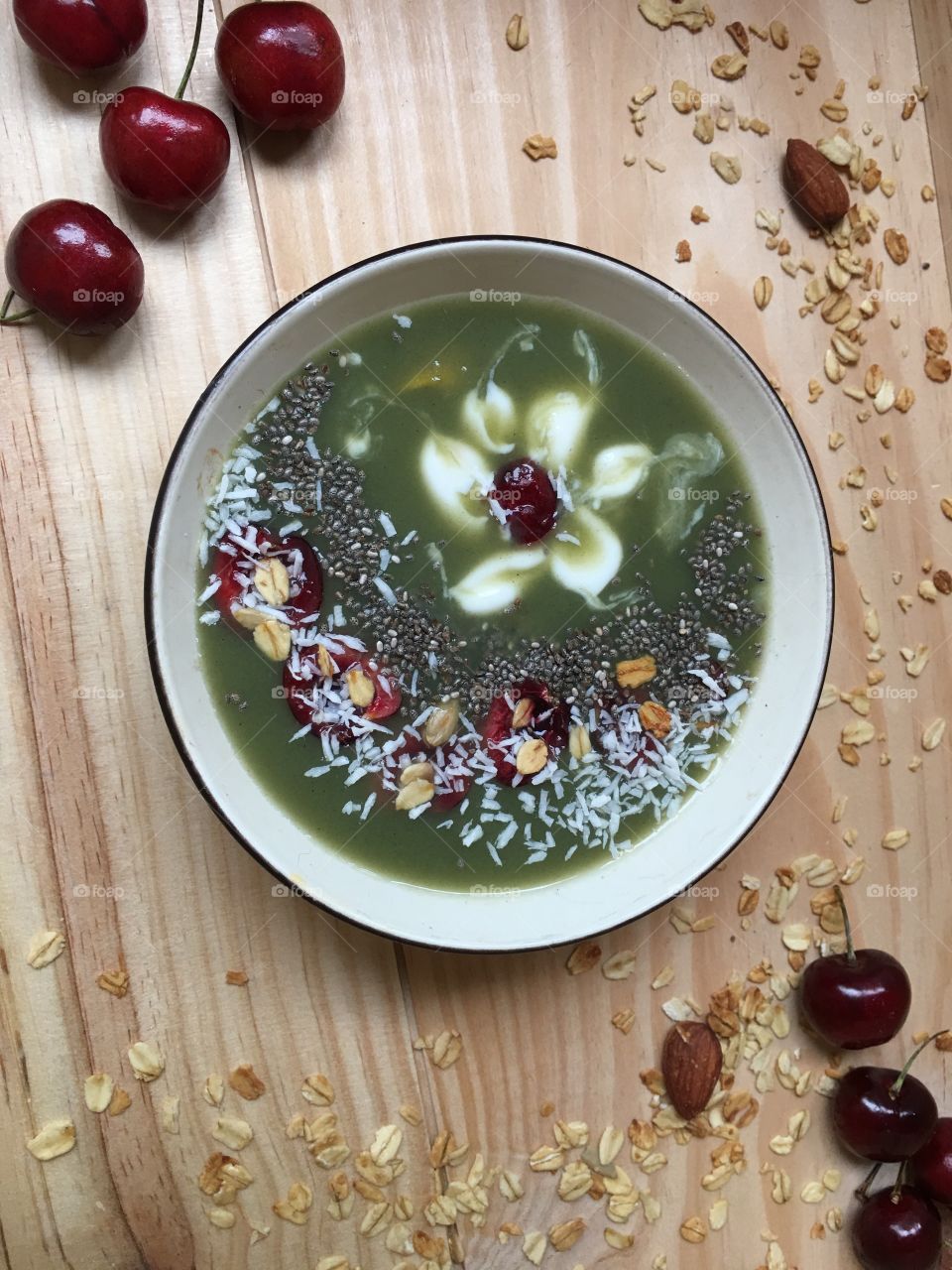 Green cherry almond smoothie with flower design