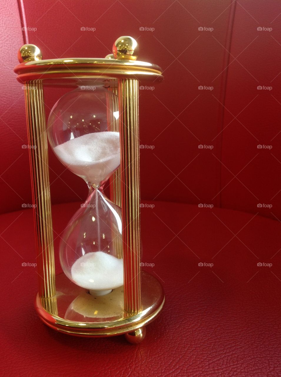 Hour glass with red background