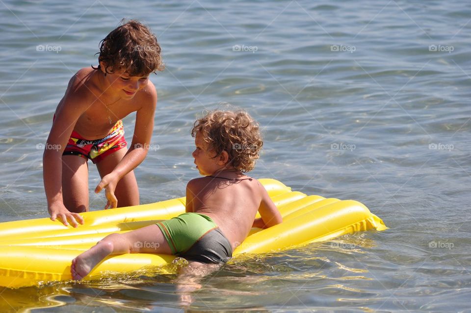Happy little boys in the beach