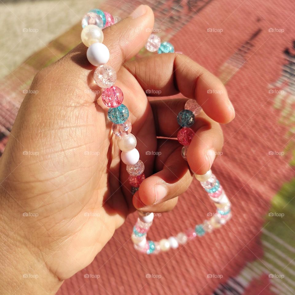 reflection of sunrays on beads and shadow