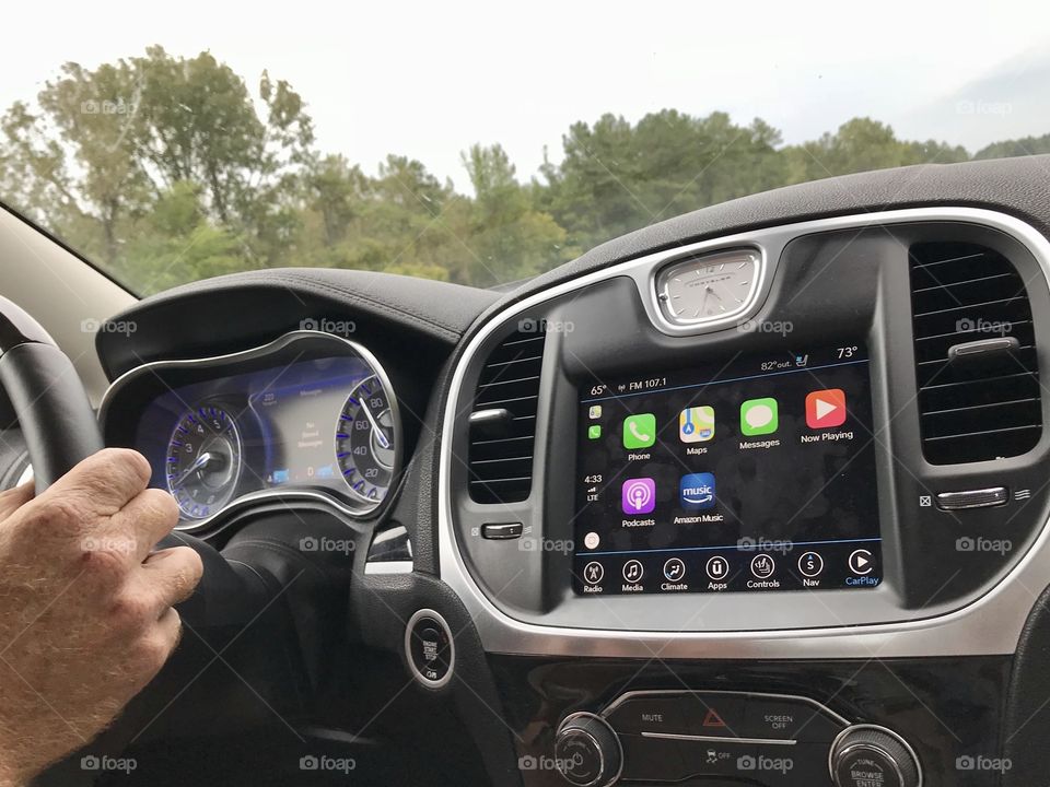 Man driving a car with a touch screen