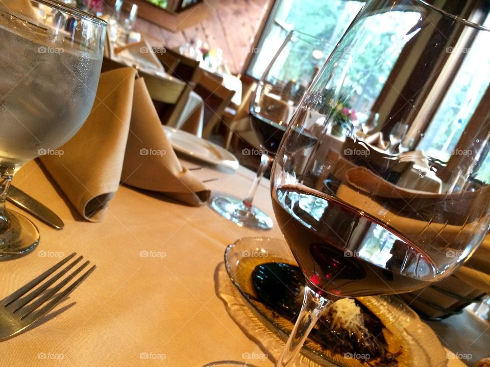 Wine glass on dining table in restaurant