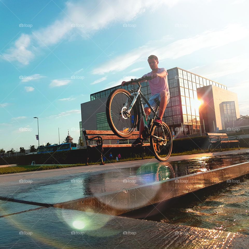 Man performing stunt on bicycle in the city