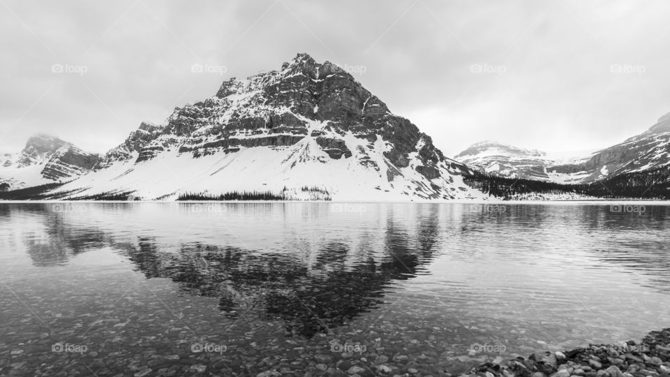 Scenic view of bow lake by mountains against sky