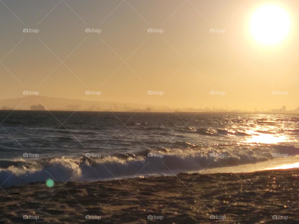 Ocean waves with a view of a beautiful sunset, the beach is one of the most relaxing places.