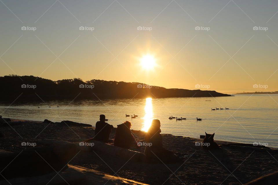 People on the beach on sunrise 