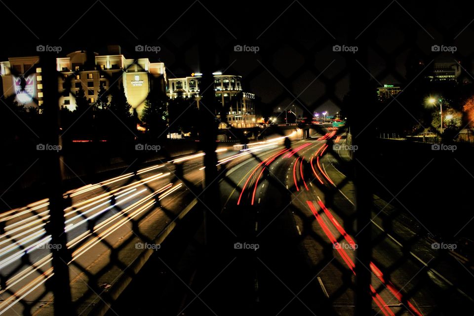 Night Lights. fence. cars. Buildings. White lights. Red lights. Enjoying the night lights on Interstate 5