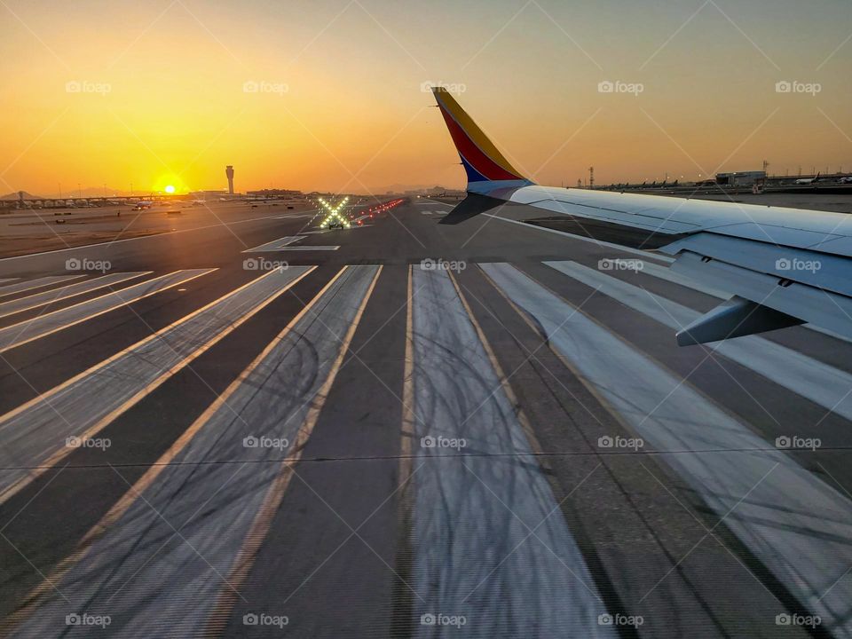 Early morning departure as the sun comes up and one runway is closed for maintenance