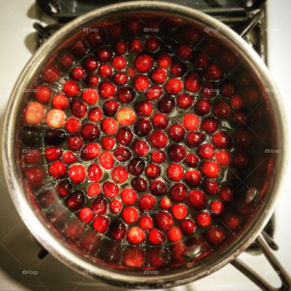 Cooking cranberries in a pot on the stove