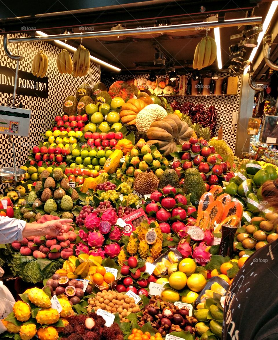 Colorful merchandise displayed in one of the La Boqueria's greengrocers in Barcelona