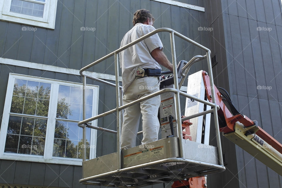 Man in a work bucket Fairhope Alabama