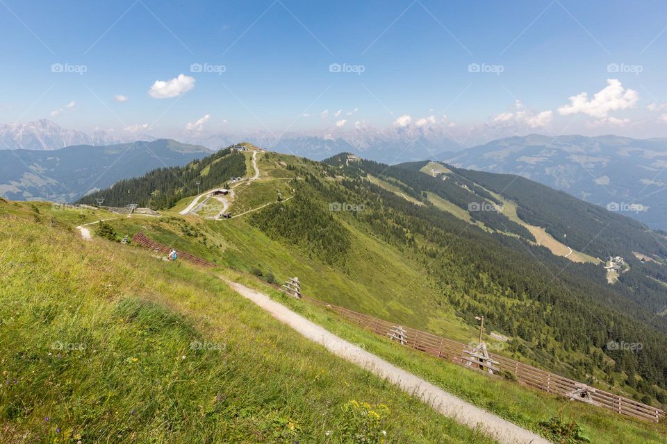 Hiking trail on mountain Schmittenhöhe Austria with panoramic view of mountain peaks