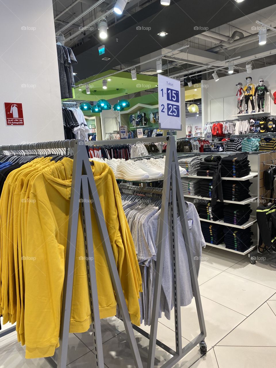 Dress showroom, photography of a shops with variety of dresses in different colors, price tags also visible 