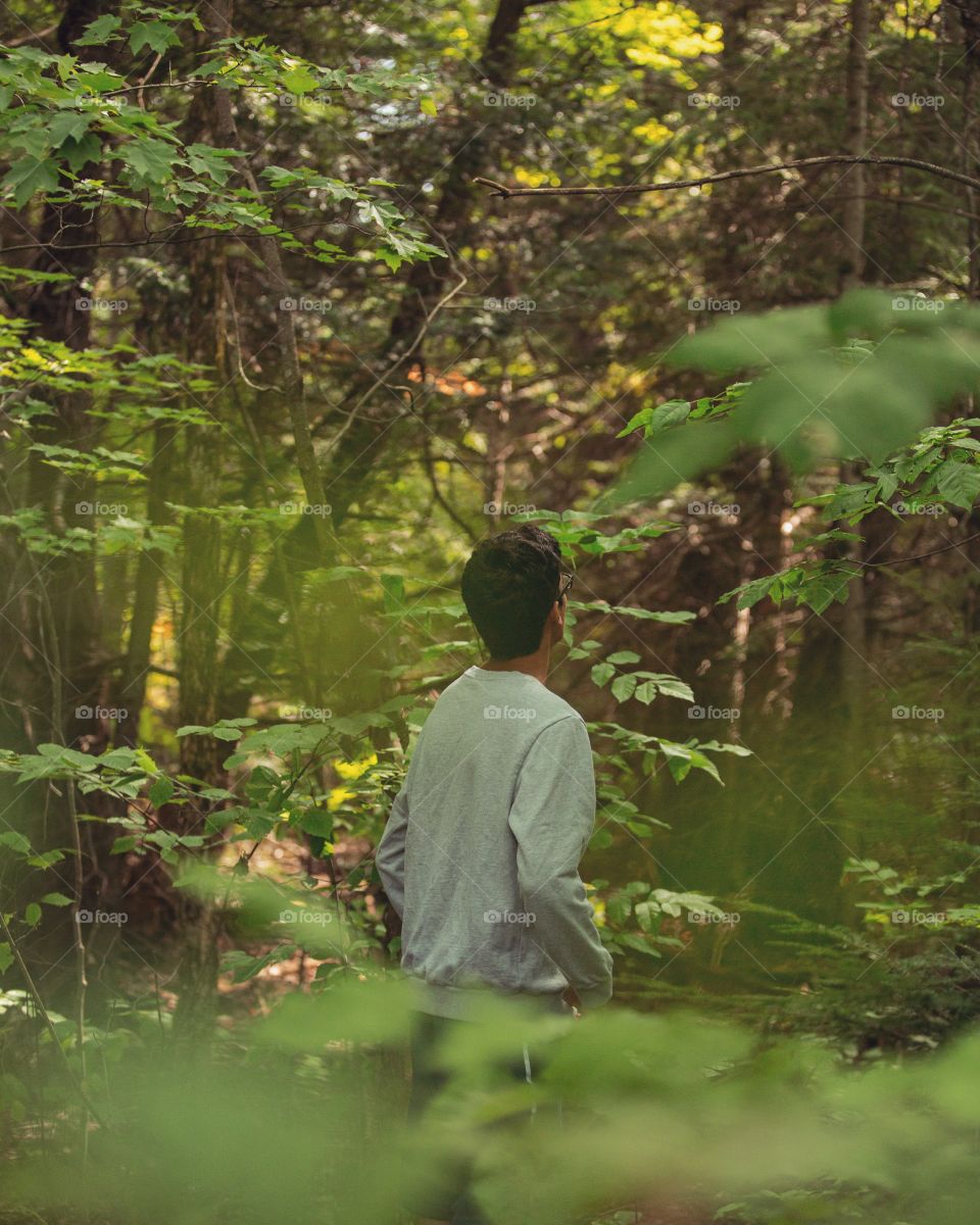 Boy in a forest walking around
