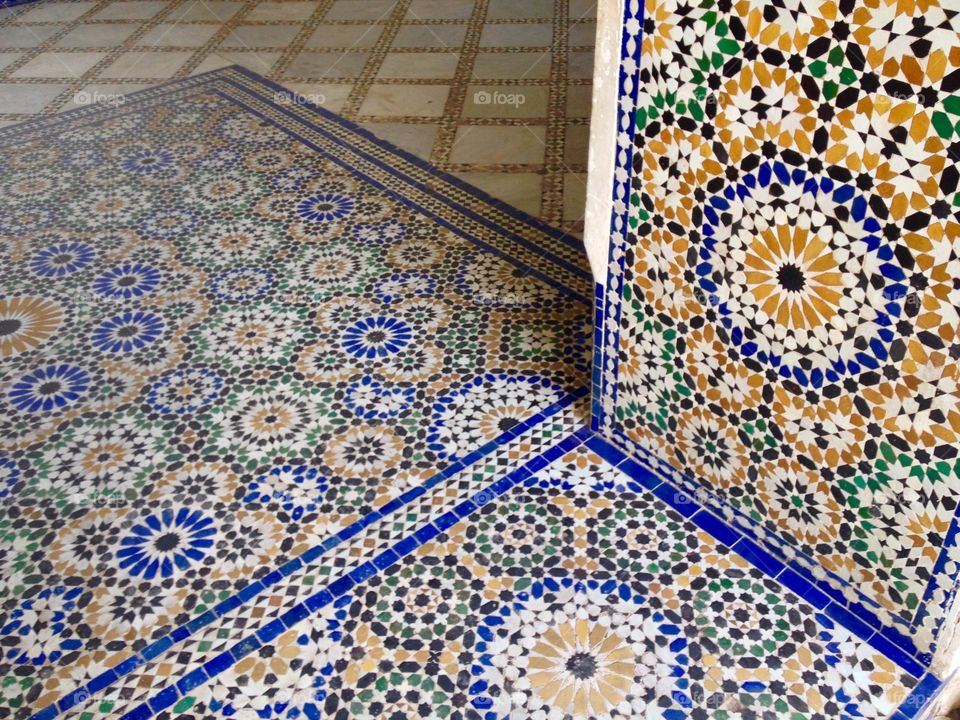 Yellow, blue, and green tiles in a doorway in Marrakech, Morocco 