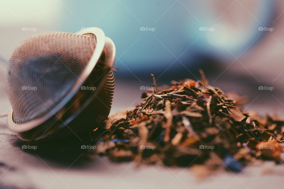 Green tea blend closeup. Green tea blend with strainer, closeup macro