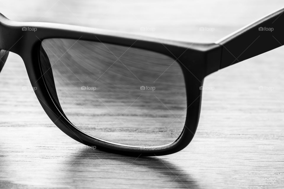 Sunglasses black and white. Sunglasses on table in black ans white. Ligt comming from the back