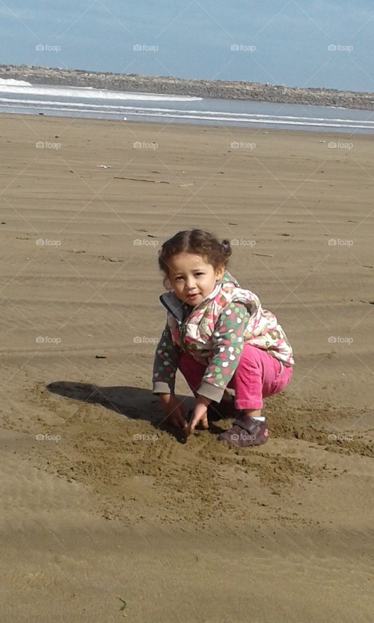 child playing with  sand