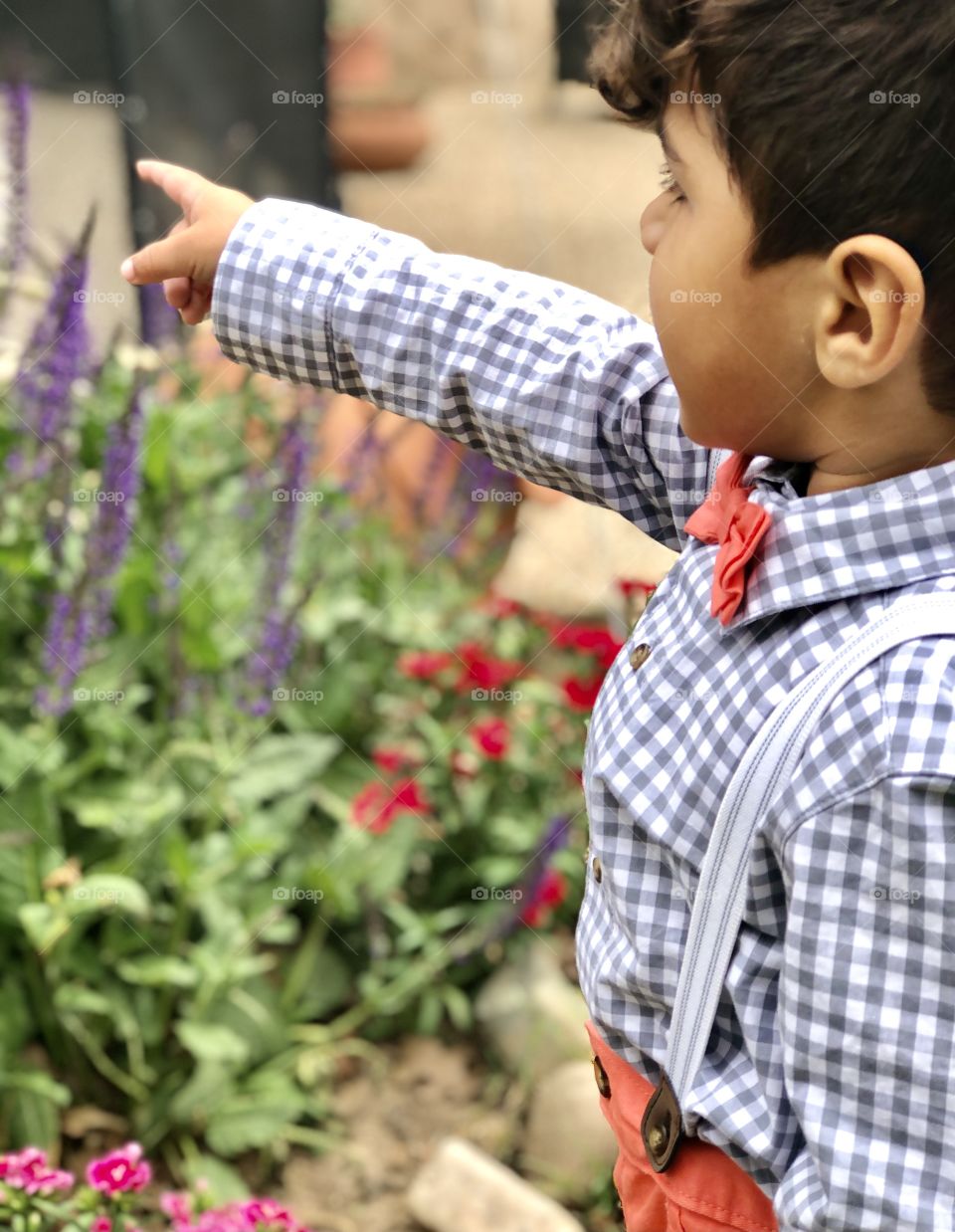 A child dressed up and pointing outside 