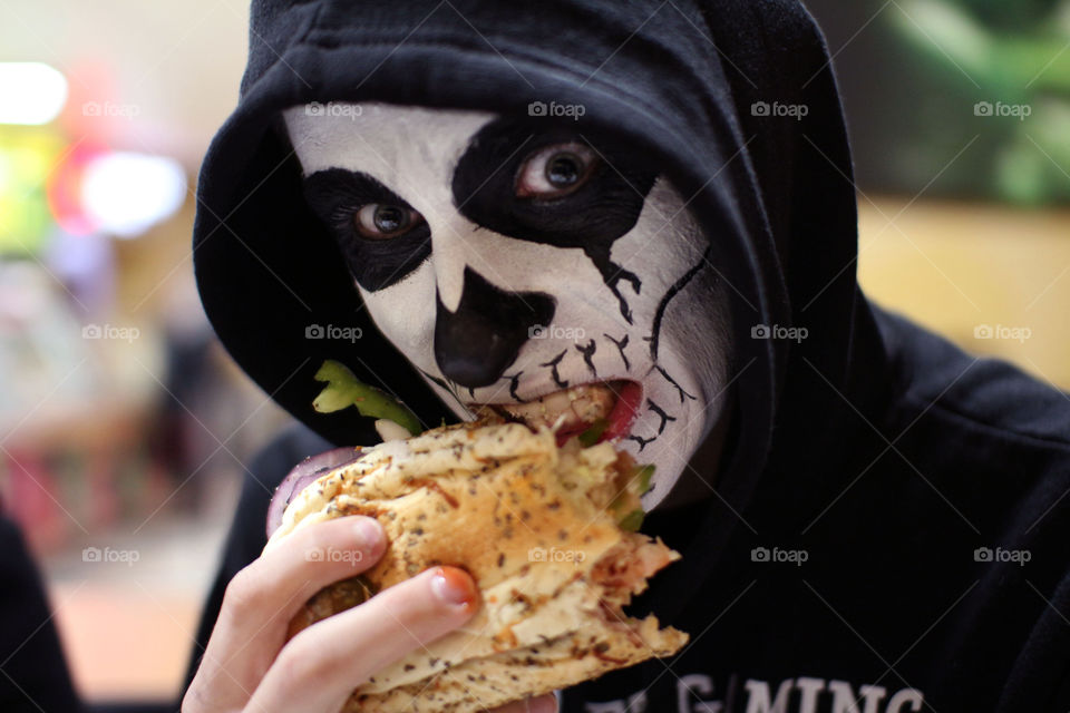 Close-up of halloween eating burger