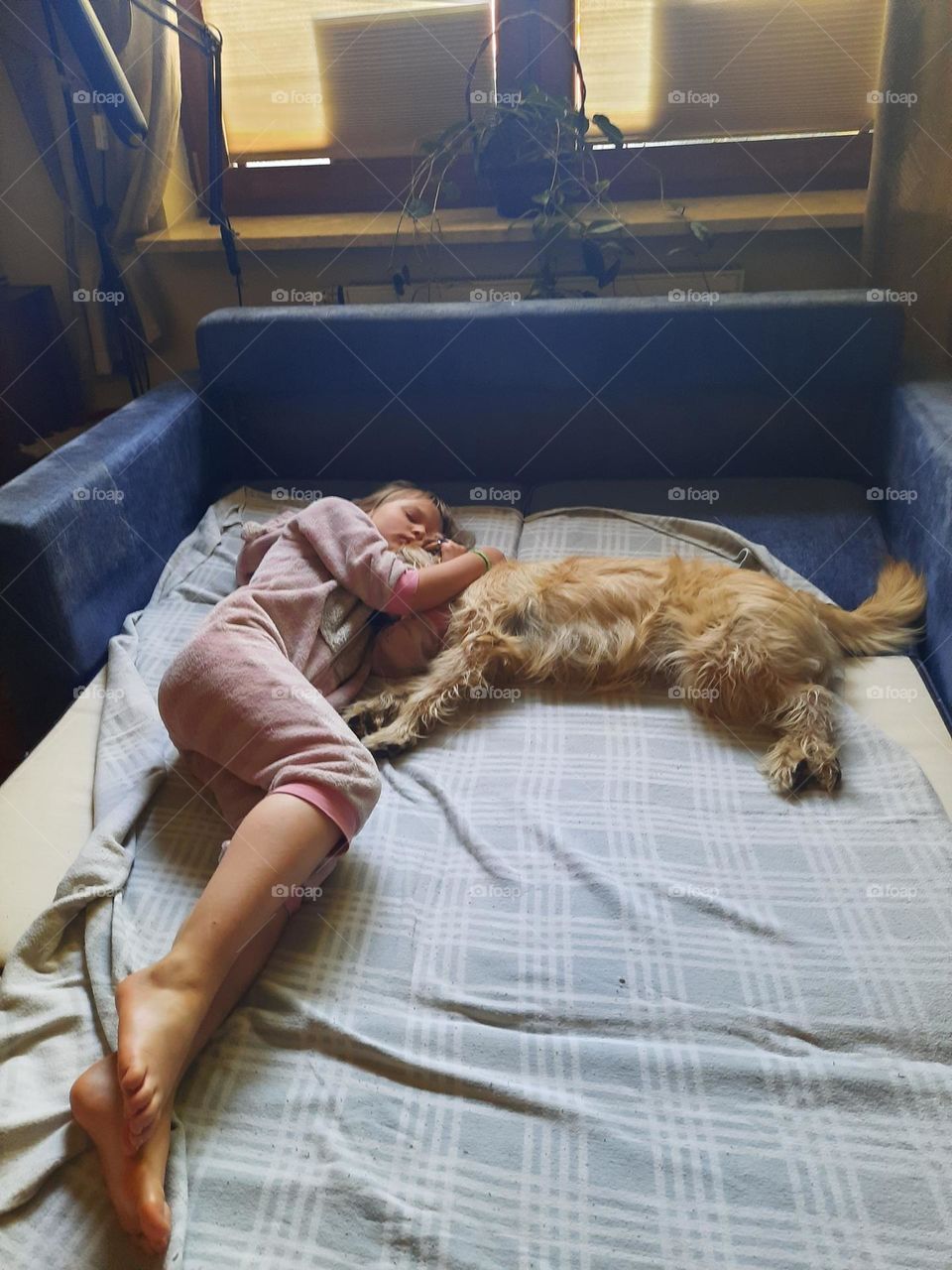 Girl sleeping with her dog