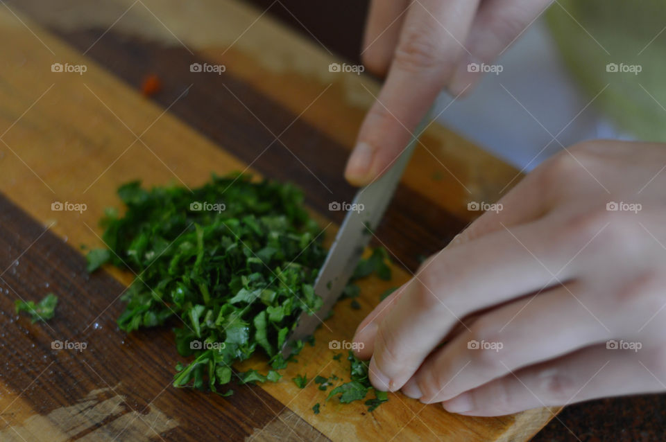 Woman chopping herb