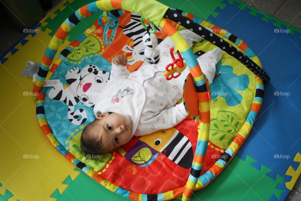 Cute baby with her favorite toy by Fisher Price