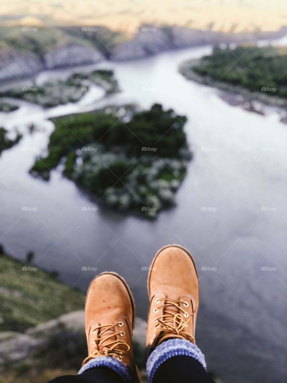 Booths hanging off ledge overlooking beautiful Montana river. 