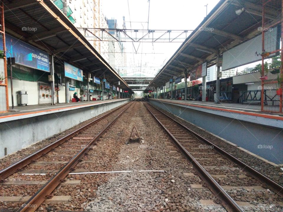 Pondok Cina station Depok Indonesia, August 12, 2021, This station is one of the stations that has not been equipped with an underpass for crossings while the pedestrian bridge is under construction